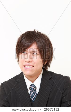 studio shot of perplexed businessman on white background