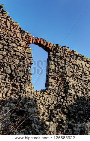 Old window of the castle fragment with the plane trail
