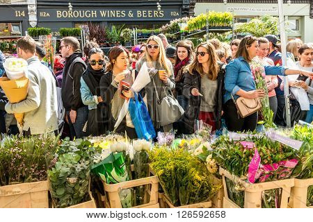 London United Kingdom - April 17 2016: Columbia Road Flower Sunday market. Street traders are selling their stock people choosing flowers
