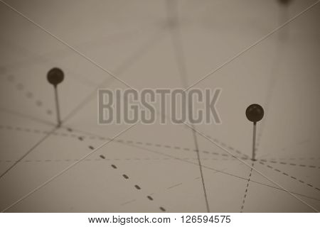Black Pins In Paper Linked By Lines