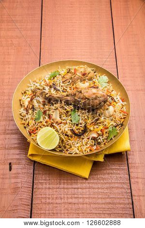 authentic chicken biryani with leg piece, prepared in basmati rice