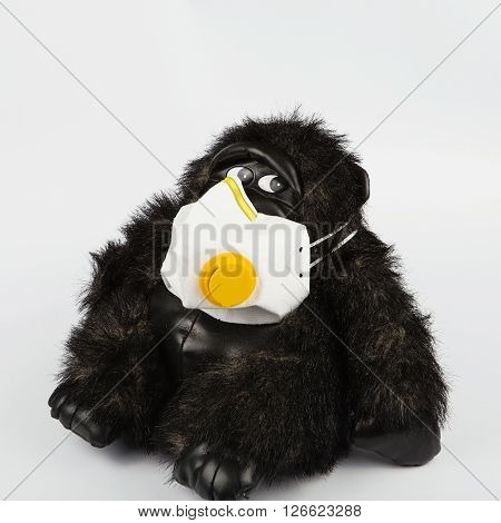 Black Toy Monkey In A Protective Mask On A White Background.