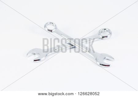 Couple of wrenchs chrome metal spanner instruments isolated over white background