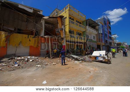 Portoviejo, Ecuador - April, 18, 2016: People gathering their belongings from building showing the aftereffect of 7.8 earthquake that destroyed the city center, and most of the Manabi province.