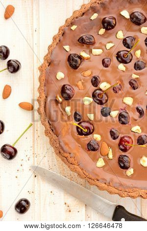 Selective focus on the sweet chocolate tart cake with cherries