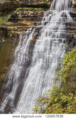 Brandywine Falls a waterfall in Ohio's Cuyahoga Valley National Park spills over a tall cliff with numerous rock ledges.