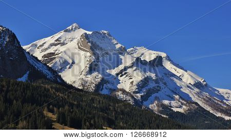 Majestic Mt Oldenhorn in spring. High mountain near Gstaad, Swiss Alps. Ski fields.