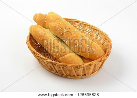 scuttle of fresh rolls with salt and caraway seeds on white background