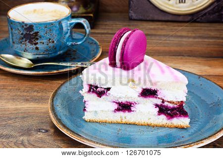 Sweet and Colourful Cake with French Macaroons with Cup of Cofee. Studio Photo