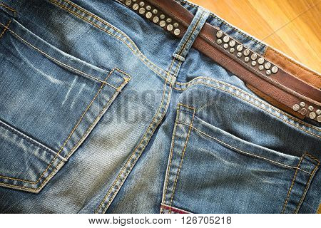 blue jeans with brown leather belt for design
