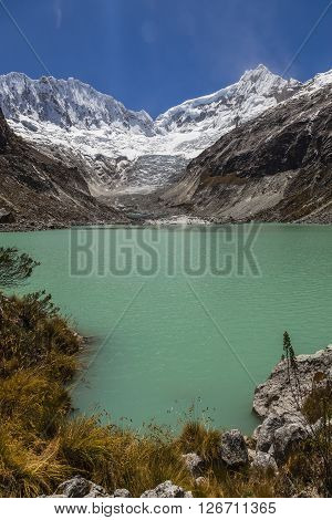 Llaca lagoon (4474 m) in the peruvian Andes and Ocshapalpa peak (5888 m) and Ranrapalca peak (6162 m) Peru