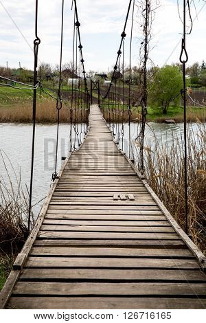 old pendant bridge over river