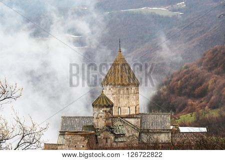 Ancient monastery Tatev covered with clouds in the mountains of Armenia. Was founded in year 906. 