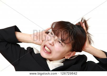 studio shot of demented businesswoman on white background
