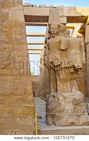 LUXOR EGYPT - OCTOBER 7 2014: The ruins of statue of the deity Amun Ra in the Hypostyle Hall of Karnak Temple  on October 7 in Luxor.