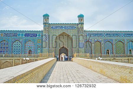 KOKAND UZBEKISTAN - MAY 6 2015: The central portal of the Palace of Khudayar Khan is richly decorated with the arabic calligraphy and islamic patterns made on the blue glazed tiles on May 6 in Kokand.