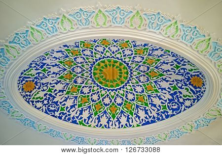 KOKAND UZBEKISTAN - MAY 6 2015: The ellipse decoration on the plaster ceiling with in Museum of Jami Mosque on May 6 in Kokand.