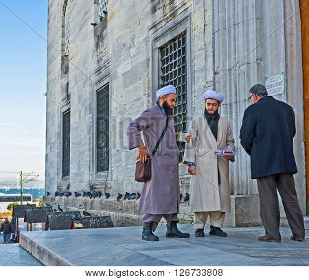 ISTANBUL TURKEY - JANUARY 21 2015: The mullas collect the sadaqat (donations) at the entrance to the New Mosque in the city center on January 21 in Istanbul.