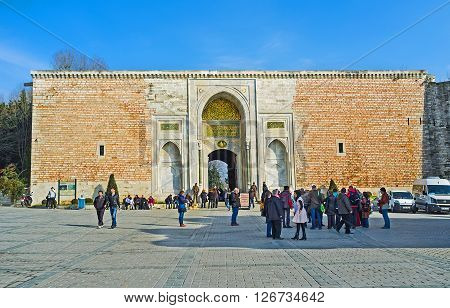 ISTANBUL TURKEY - JANUARY 21 2015: The Royal Gate of Topkapi Palace with the goups of tourists waiting the excursion on January 21 in Istanbul.