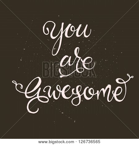 Handwritten vector lettering phrase You are awesome. Brush lettering calligraphy style writing. Whimsical letters on dark chalkboard looking scratched textured surface. Perfect for t-shirt design