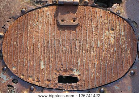 Old rusty metal hatch of a bridge.