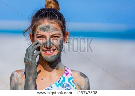 Portrait of beautiful girl taking Mud SPA At The Dead Sea, Israel.