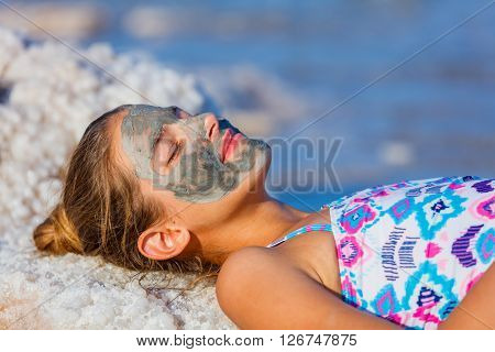 Portrait of beautiful girl taking Mud SPA At The Dead Sea, Israel.