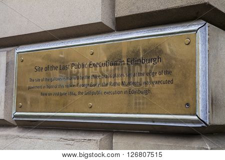 EDINBURGH, UK - MARCH 11TH 2016: A plaque on the Royal Mile detailing the site of the last public execution in Edinburgh which took place in 1864, taken on 11th March 2016.