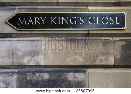 EDINBURGH, UK - MARCH 12TH 2016: A direction sign pointing towards Mary Kings Close on the Royal Mile in Edinburgh, ON 12th March 2016. It is the location of the Real Mary Kings close - one of the many popular tourist attractions in the city.