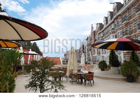 Kemer, ANTALYA, TURKEY - MAY 30, 2015: Street with original buildings and colored umbrellas in hotel Orange County Resort, Turkey.