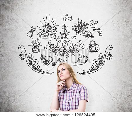 Thinking female with abstarct drawings on concrete wall