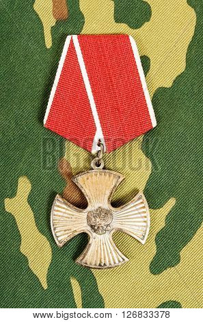 SAMARA RUSSIA - APRIL 20 2016: Order of bravery on the camouflage background