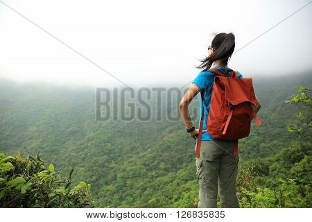 young asian woman enjoy the view at mountain peak
