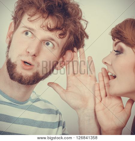 Woman Telling An Astonished Man Some Secrets