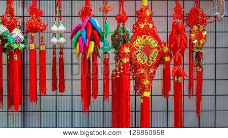 Chinese amulets put for sale on the side of a street at Yokohama Chinatown