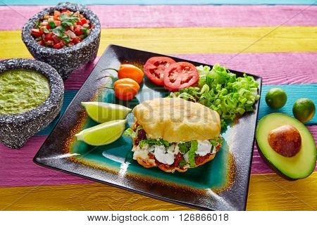 Gordita mexican fried puff corn taco filled with pastor meat lettuce and cream