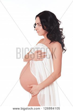 Beautiful pregnant woman standing over white background. Looking away. Maternity. Motherhood. Healthcare. Healthy lifestyle.