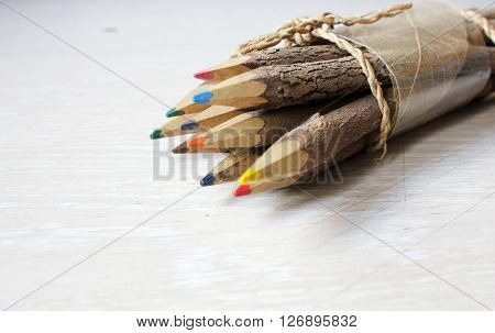 Wooden pencils on a white wooden table.