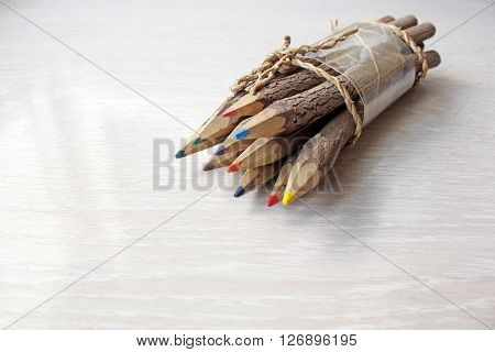 Wooden pencils on a white wooden table.