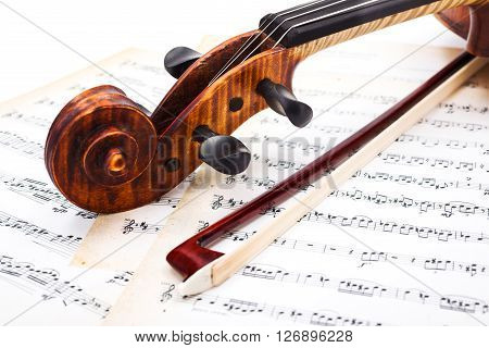 Close View Of Violin Scroll And Bow