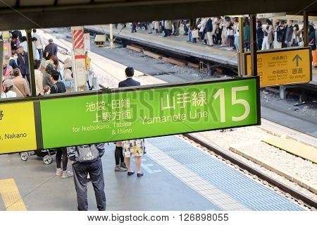 TOKYO - MARCH 31, 2016: The Yamanote Line sign (Yamanote-sen) is Tokyo's most important train line,People waiting for rail train at Tokyo main railway station in March 31, 2016 Tokyo, Japan.