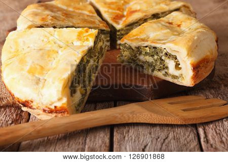Tasty Sliced Greek Pie With Spinach And Cheese Close-up. Horizontal