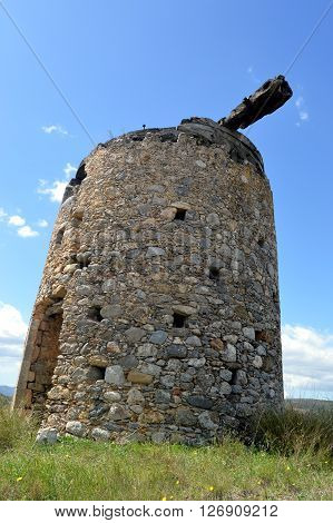 An old mill gets wind in Greece.