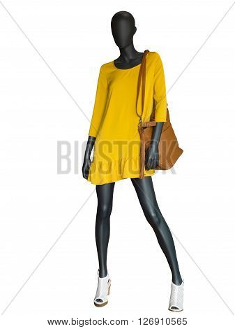 Full-length female mannequin dressed in yellow dress isolated on white background.