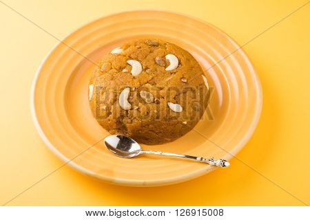 Moong Dal Halwa - a sweet dish from India, Indan Sweet Halwa made from Moong Dal, moong dal sweet sheera or shira cooked in pure ghee, served in a yellow ceramic plate