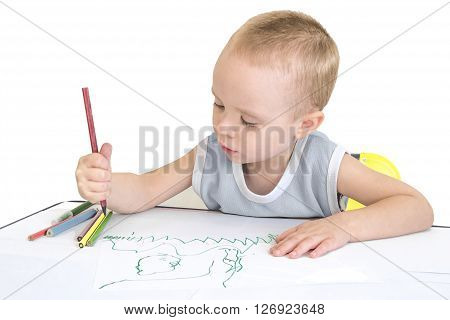Little boy drawing with crayons. Isolated on a white background.