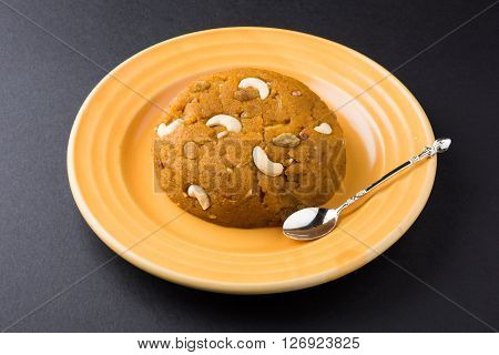 Moong Dal Halwa - a sweet dish from India, Indan Sweet Halwa made from Moong Dal, moong dal sweet sheera or shira cooked in pure ghee, served in a yellow ceramic plate