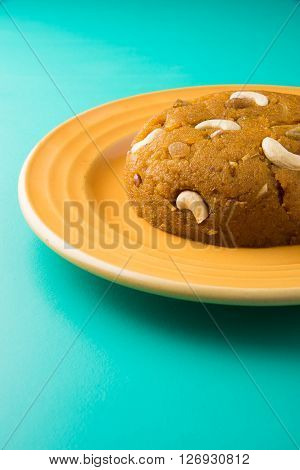 Moong Dal Halwa - a sweet dish from India, Indan Sweet Halwa made from Moong Dal, moong dal sweet sheera or shira cooked in pure ghee, served in a yellow ceramic plate