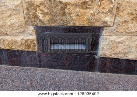 Embedded in the granite pavement lights. Lighting of the sidewalk.