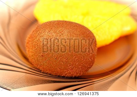 Kiwi dark color  on a black shade on orange background